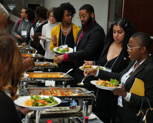 Conference attendees serve themselves lunch via a buffet
