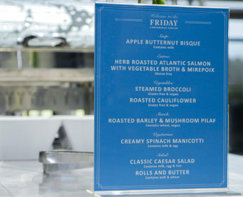 A menu greets attendees as they queue for lunch