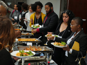 Conference attendees serve themselves lunch via a buffet